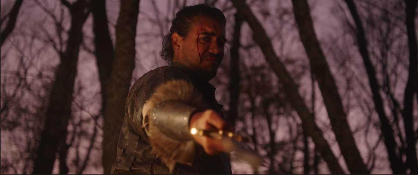 Cynewulf, bleeding, levels a sword under a violet sky